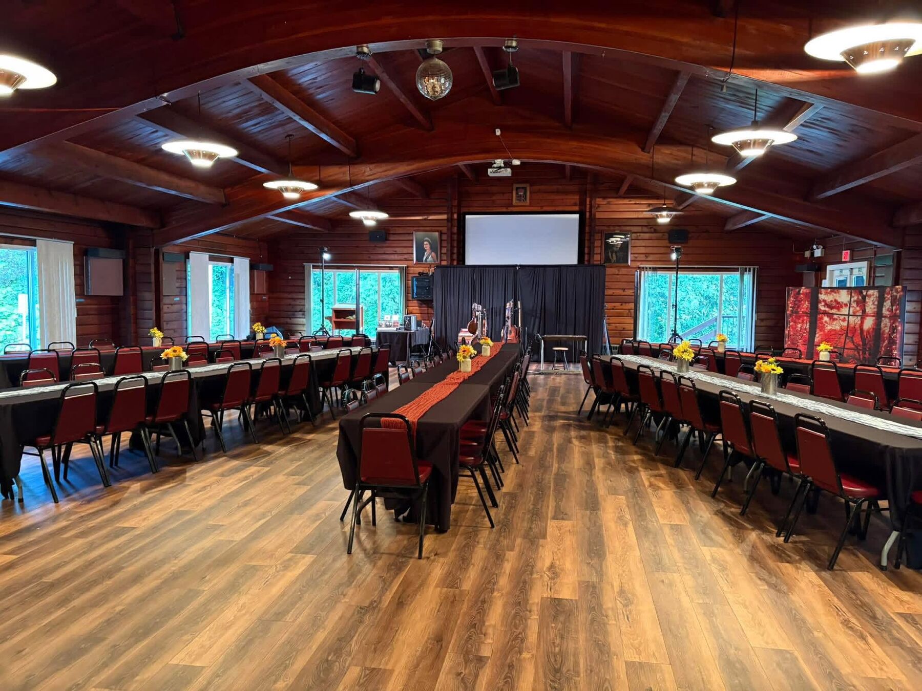 The upstairs hall set with long tables under its wood beam ceiling